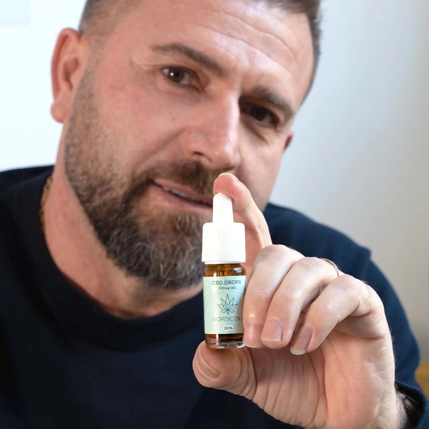 a man holds the cbd oil