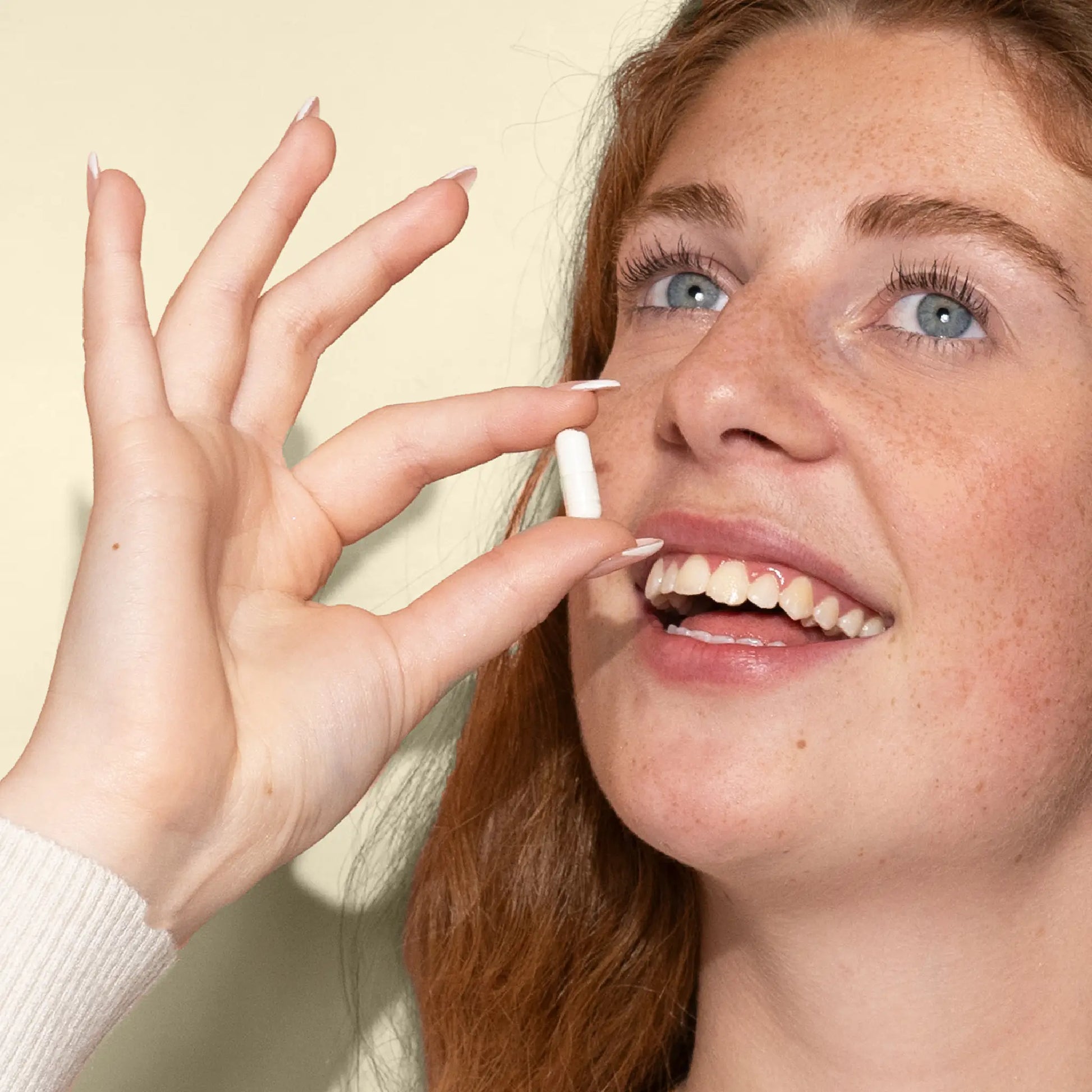 woman takes vitamin c capsules