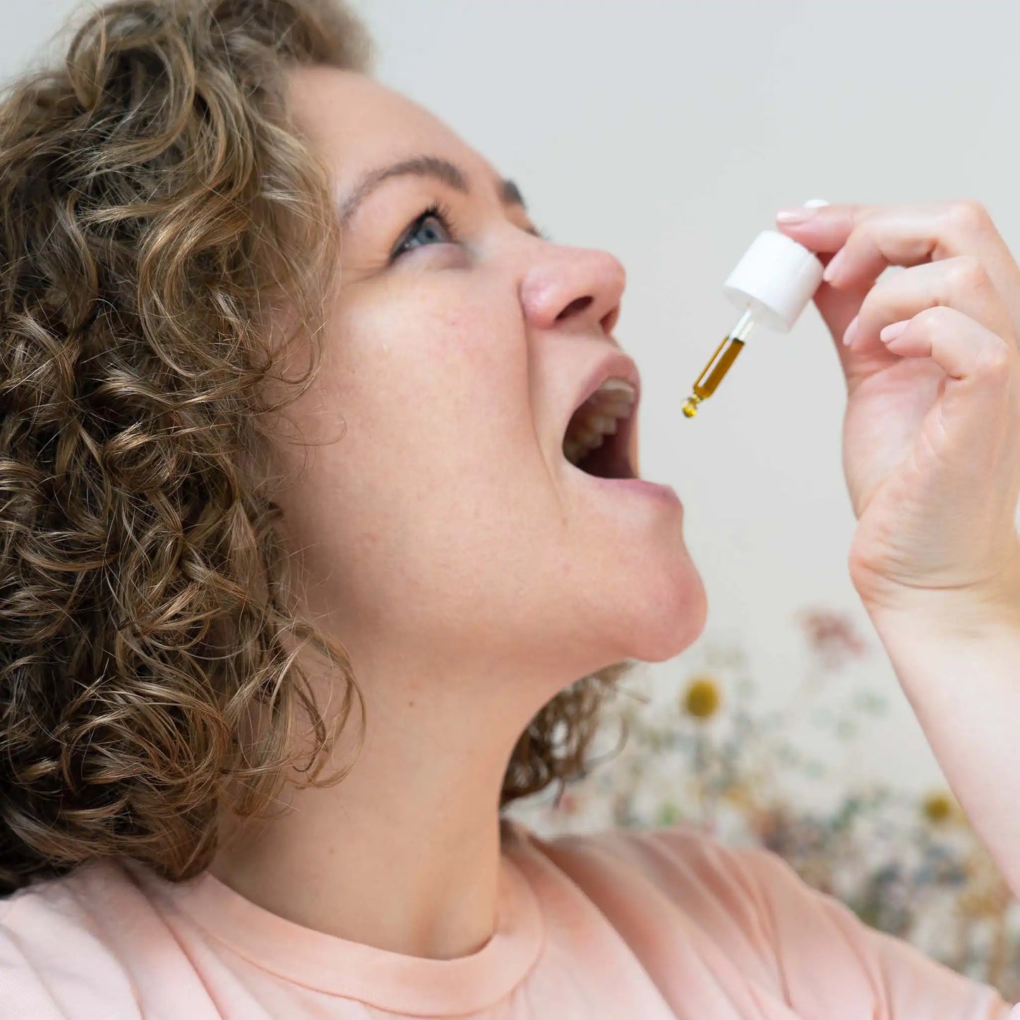 a woman drops CBG in her mouth