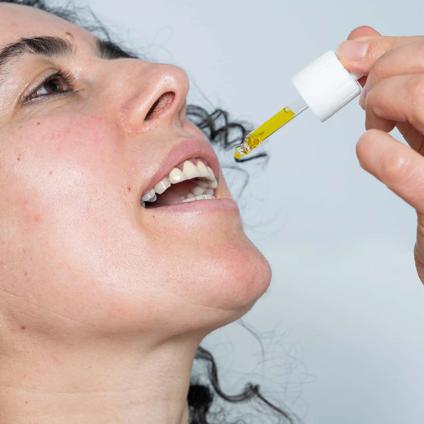 a woman consumes the cbd oil