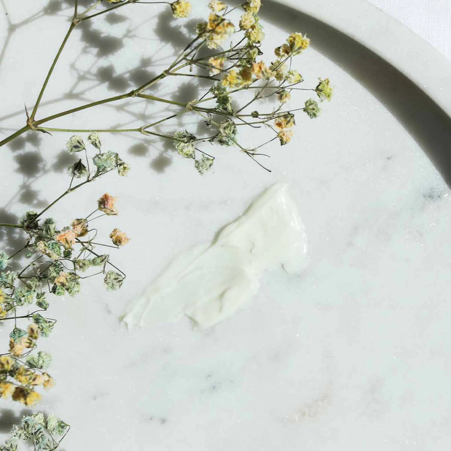 the cream was spread on a table and next to it is the product