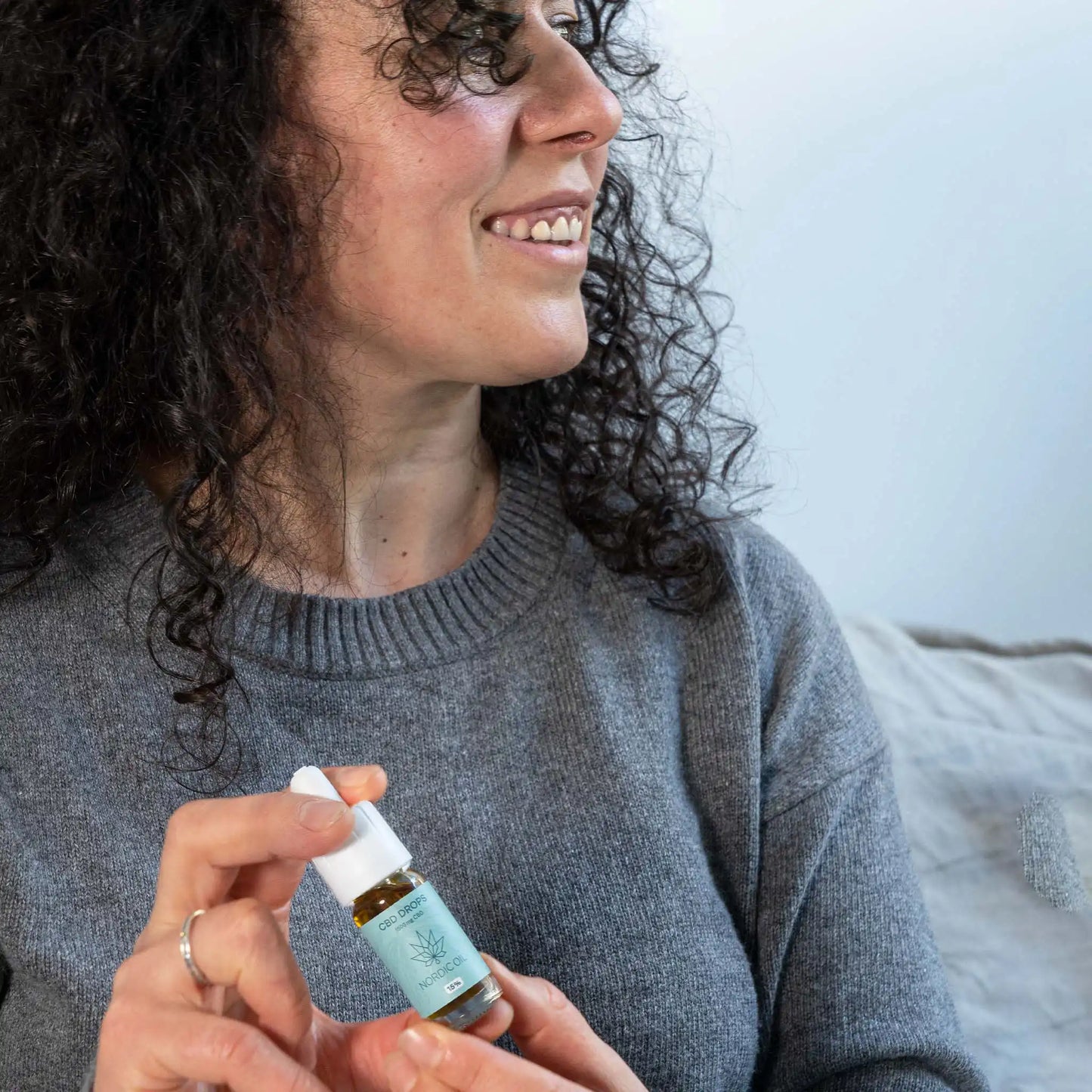 a smiling woman holds the product