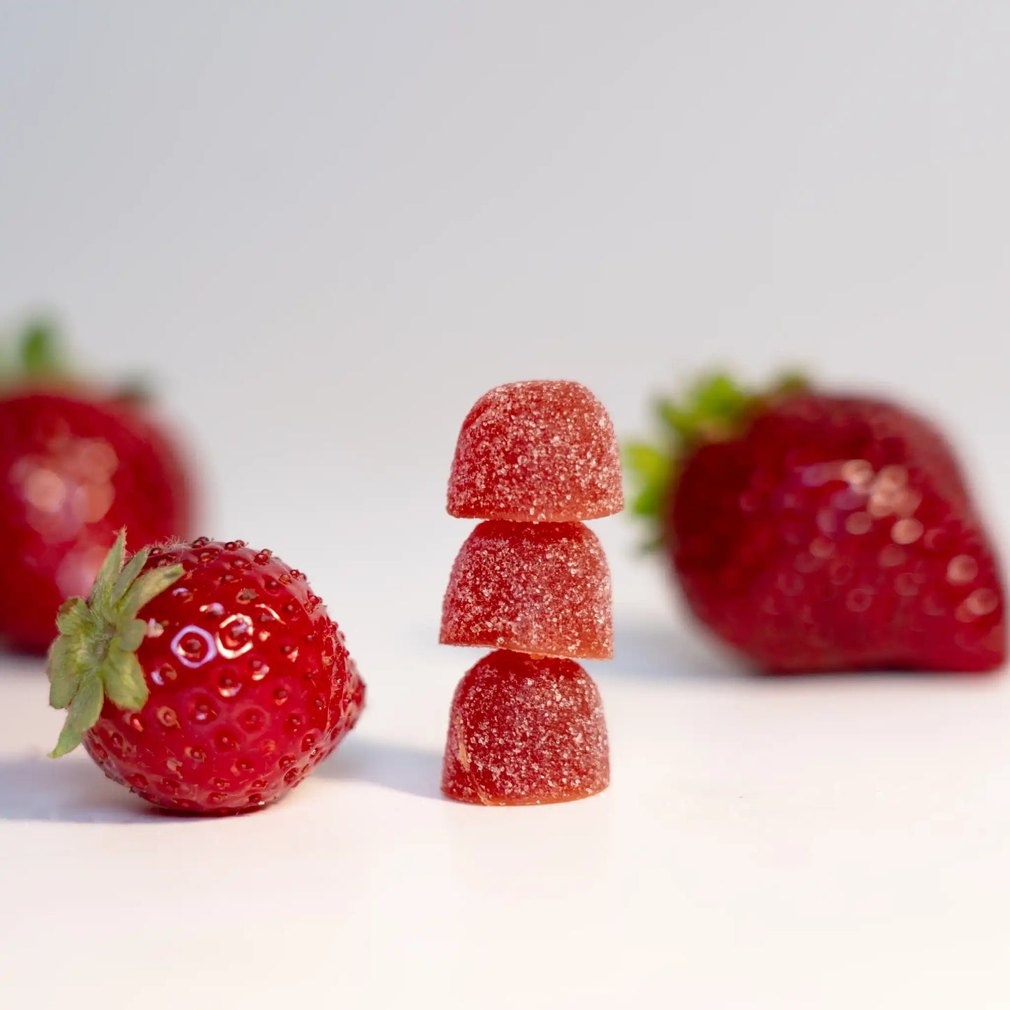 Three CBD gummies with strawberries