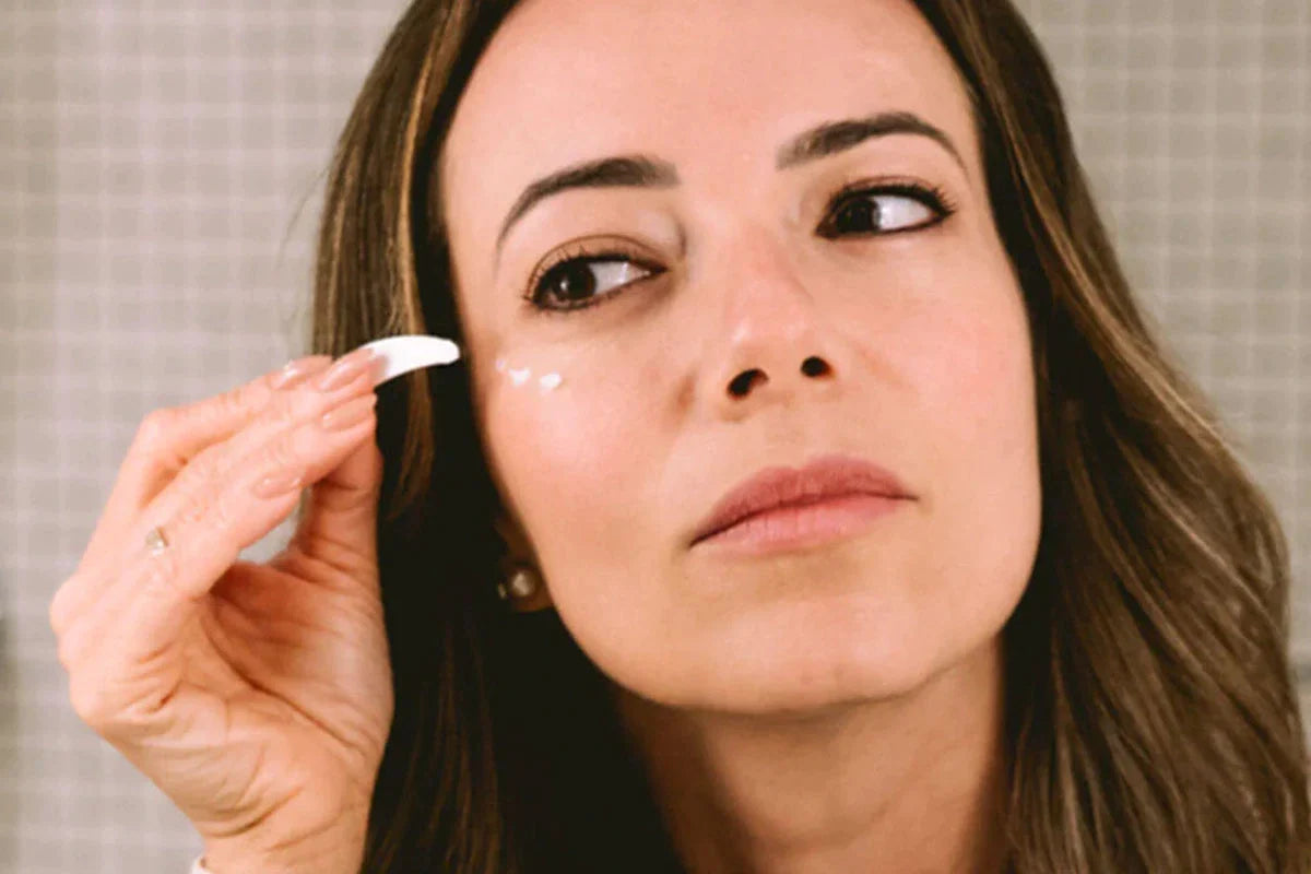 woman using eye cream