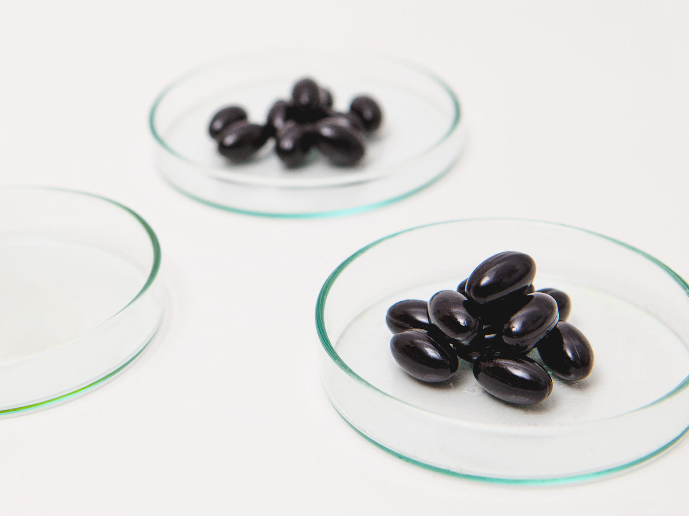 CBD capsules lie in glass bowls.