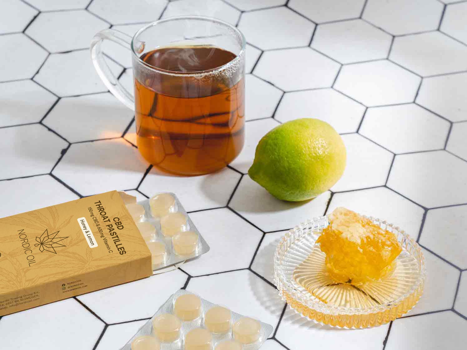 cup of tee next to a lime honey and cbd pastilles