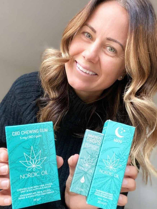 A woman is holding CBD chewing gum 